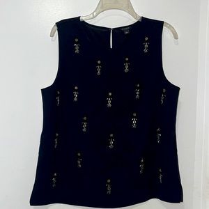 Shell- embroidered with shiny beads.